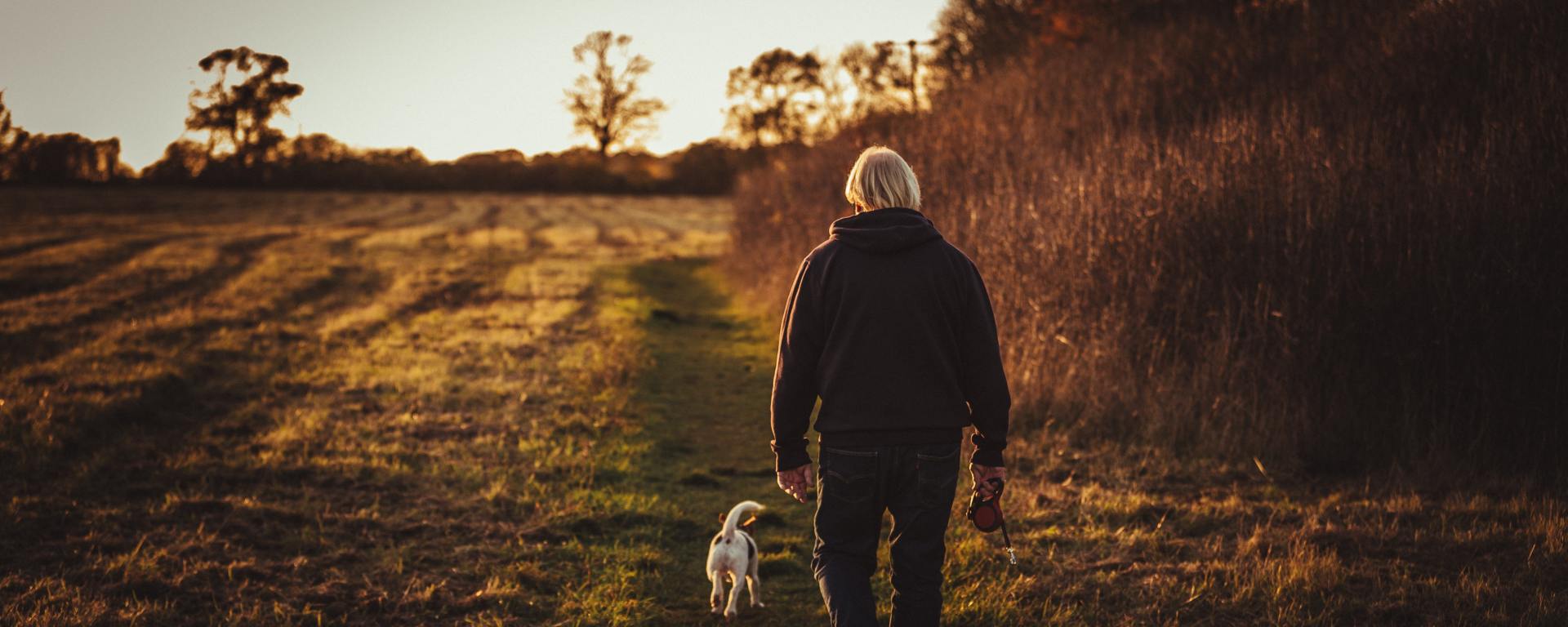 Old man walking with a dog