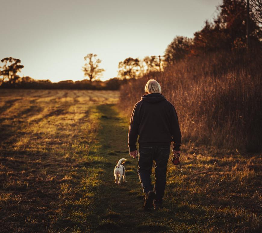 Old man walking with a dog